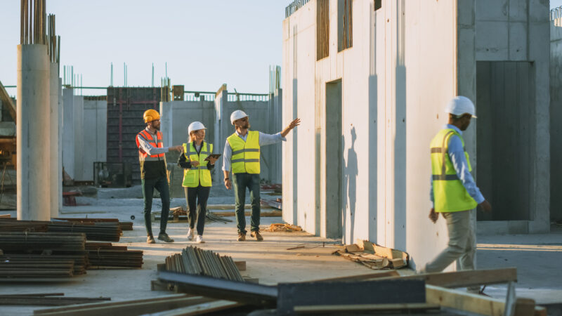 A team of specialists walk through a construction site